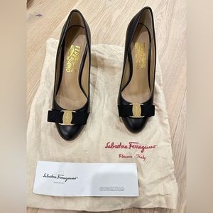 Black leather gold bow buckle Salvatore Ferregamo heels. Size 7